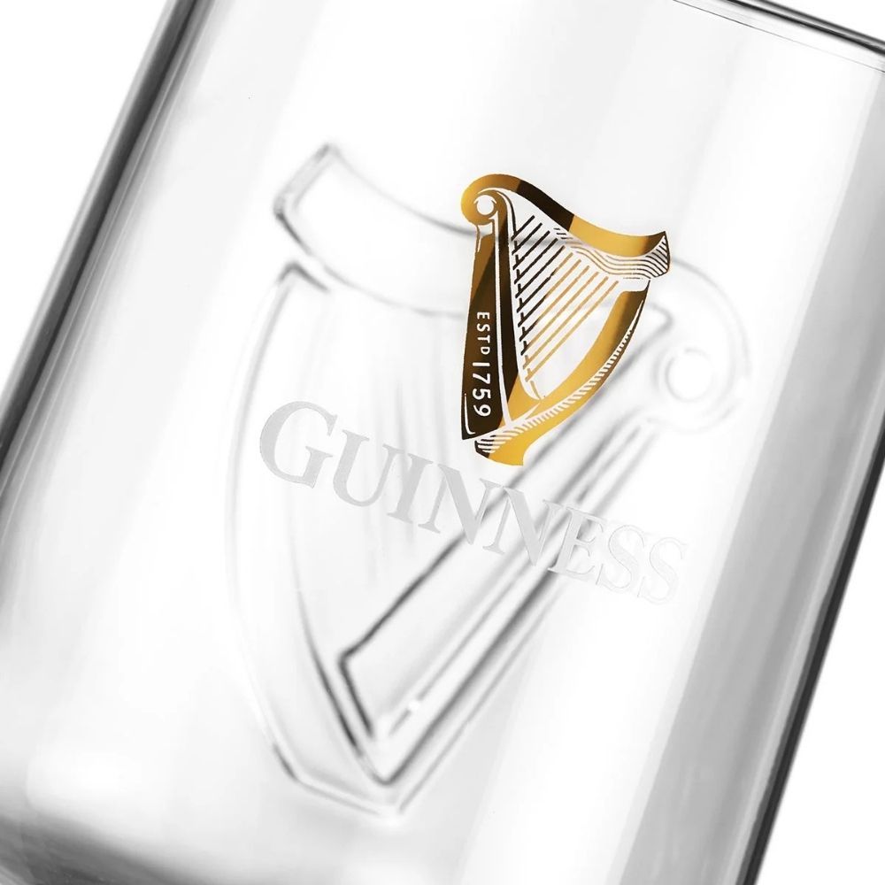 Close-up of a Guinness glass with the embossed harp logo